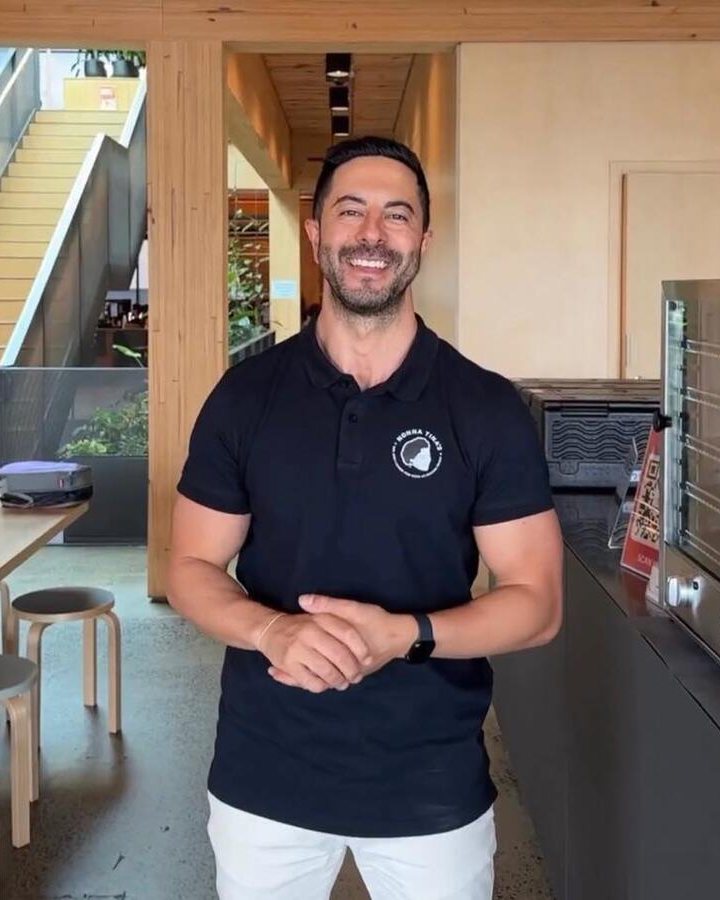 Adam Agresta, founder of Promptwise Advisory, smiling in a Sydney office