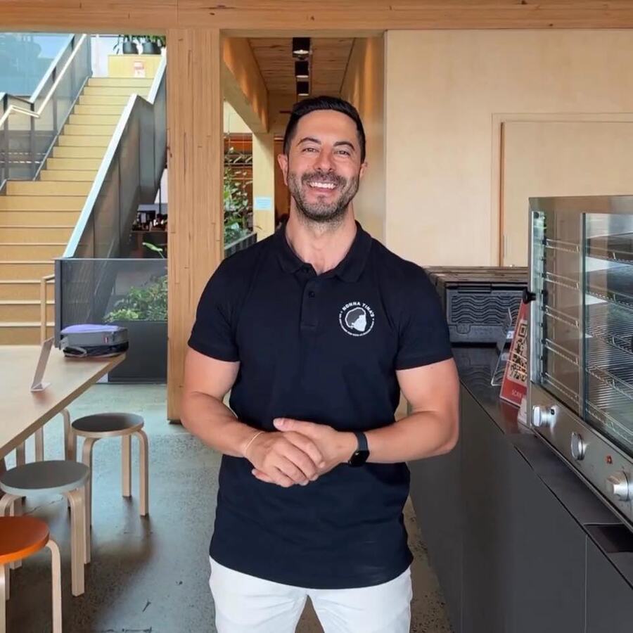 Adam Agresta, founder of Promptwise Advisory, smiling in a Sydney office