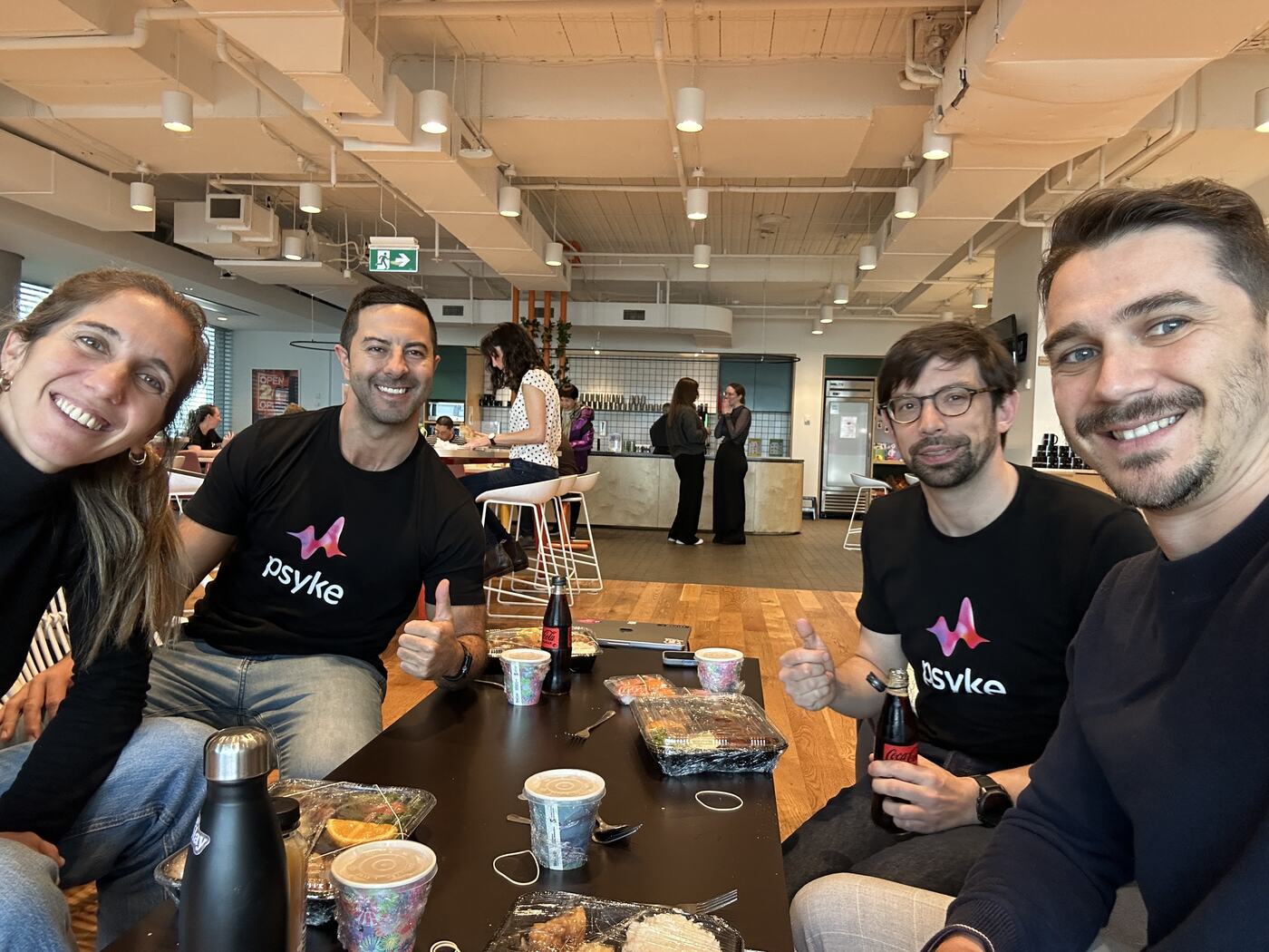 Adam having lunch with the Psyke team in the office