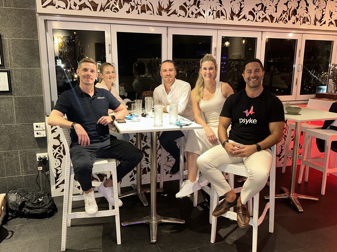 Adam with partners and friends at an evening networking dinner
